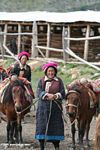 Older Tibetan woman waiting to lead horses