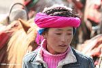 Young Tibetan woman using a pink scarf as a headband