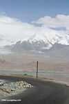 Karakoram highway with a turquoise lake in the background