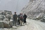 Tajik family walking along a dusty road