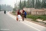 Uighur children working along a highway near Kashgar