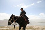 Uygur boy on horseback at Karakul Lake