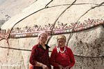 Uighur women standing in front of their traditional yurt