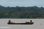 Two boys sitting in a dugout on the Amazon river