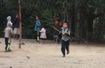 Children playing a traditional top spinning game in Laos