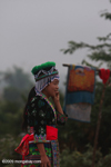 Hmong girl in traditional clothes chatting on her mobile phone