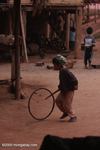 Boy pushing a hoop with a stick