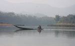 Man paddling across the Nam Ou river