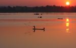 Men fishing on the Mekong at sunrise