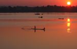 Men fishing on the Mekong as the sun rises