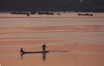 Man bailing his boat on the Mekong